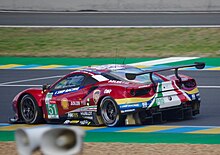 A cherry red Ferrari 488 GTE Evo as viewed from a near side angle