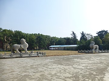 A very large pair of winged, stone pixiu guarding a tomb in China