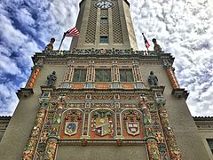 Closeup of the tower designs with the seals of Harvard University and the National University of San Marcos next to the one of the University of Puerto Rico