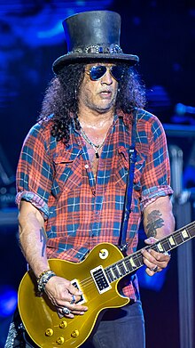 Slash playing guitar onstage