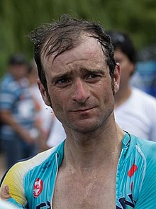 Michele Scarponi wearing a light blue cycling jersey with a yellow shoulder