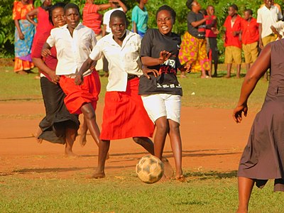 This is a football match between women and girls in Muguluka, Jinja, Uganda during the Women's Day Celebration event. The women beat the girls 1-0.