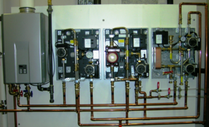 Modern factory assembled hydronic control appliances for underfloor heating and cooling, shown with covers off