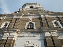 The church's façade showing the papal symbol or the Papal Cross Keys