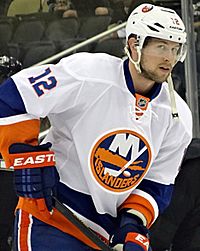 Josh Bailey on the ice holding his hockey stick.