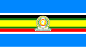 Nine horizontal strips coloured (from top to bottom): blue, white, black, green, yellow, green, red, white, then blue. The emblem of the EAC is placed in the centre.