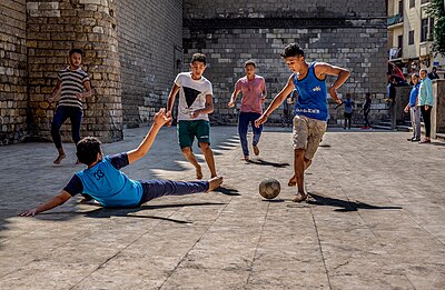 Boys playing street football in Egypt