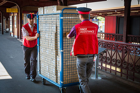 Two men wearing gilets at Strasbourg railway station in France.