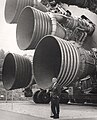 Wernher von Braun posing with the Saturn V's S-IC engines in Huntsville