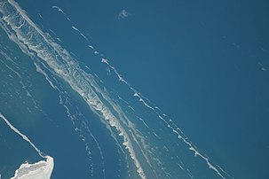 Ice stringers along the southeastern part of the island at 1:52:46 PM Central Standard Time on February 22, 2014. North is towards the left in this photo taken during Expedition 38 of the International Space Station