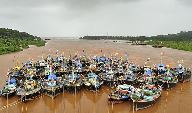 Fishing boats lashed together in the the Indian village of Anjarle to protect against the oncoming monsoon, whose clouds are visible nearby (created by Dey.sandip; nominated by I-82-I)