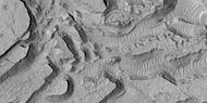 Enlarged view of a group of mesas, as seen by HiRISE under HiWish program One surface is forming square shapes.