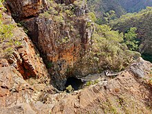 A photo taken looking down from the top of the waterfall to the viewing platform below.