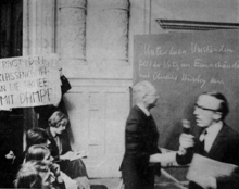 Studierende der Universität Bern protestieren im Jahr 1968 eine Vorlesung. Auf einem Schild steht "Tragt den Klassenkampf in die Armee mit Dampf".