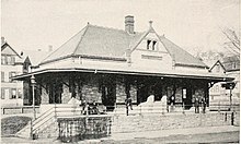 A black-and-white photograph of a small stone railway station