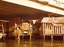 Shack built out of metal and wood under bridge