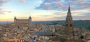 A cityscape; two tall buildings dominate the view, the Alcázar and the Cathedral.