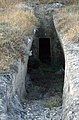 Photograph of a chamber tomb, with the doorway visible.