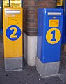 Post boxes in Heinola, Finland. Orange 2nd class postbox is very common, blue 1st class mailboxes only at selected places.