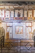 House of the Vettii VI 15,1 Pompeii 2023 Looking towards central panel of south wall with painting showing fight between Eros and Pan with painting of Leda and the Swan courtesy of Johannes Eber.jpg