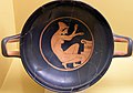 Woman kneeling before an altar. Attic red-figure kylix, 5th century BC