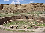 Ruins of a circular and rectangular buildings made of stones.