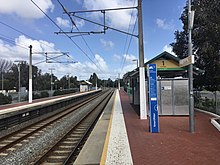 Two brick side platforms with small shelters on each