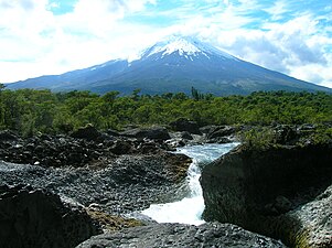 Petrohué Waterfalls (Saltos del Petrohué) with Osorno volcano in the background.