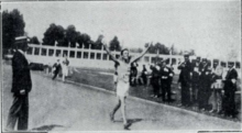 Photographie montrant Ugo Frigerio les bras levés dans le stade.