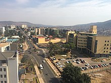 Panorama photograph showing buildings, car parks and a street with cars