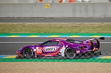 A purple Ford GT with the number 85 inside a purple square painted to the right of the front-left wheel as viewed from the side