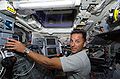 Joseph Acaba operating the robotic arm of Discovery