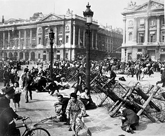 Crowds celebrating the liberation of Paris scatter from German sniper fire August 1944. Rue Saint-Florentin is in the background.