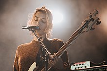 Lindberg performing with Warpaint at the 2017 Roskilde Festival.