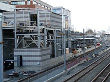 A light rail station being constructed in a railway cut