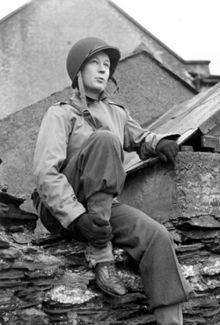 Picture of Helen Kirkpatrick in US Army combat uniform and wearing a steel helmet. Picture taken in February 1944 by Ernie Marquardt of the US Army Pictorial Service