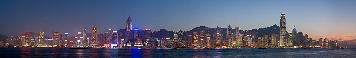 Nighttime skyline of a city, with a large body of water in front