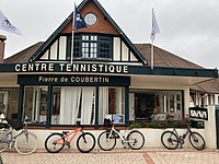 Entrance to a building that says "Centre Tennistique Pierre de Coubertin"