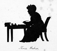 Silhouette of a woman working at a desk