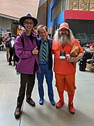 Three brightly folks; they are purple, blue, and orange themed