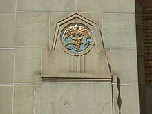 An anchor and caduceus on the exterior of a building