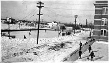 Children playing on an outdoor ice rink in the winter at the Collège des Jésuites in Edmonton