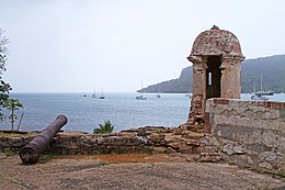 Battlements and an old cannon, overlooking a harbour.