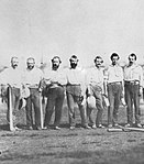 Adams standing in the middle of a group of New York Knickerbockers in 1859
