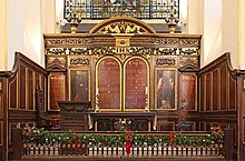 Church altar with four wooden panels, two of which show Moses and Aaron