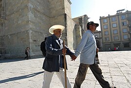 Assisting blind man walking mexico.jpg