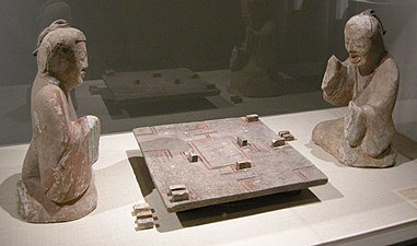 A pair of Eastern Han dynasty (25–220 AD) ceramic tomb figurines of two gentlemen playing liubo