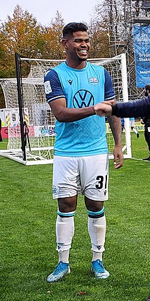 Eriks Santos in uniform, smiling