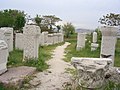 Column capitals and Roman tomb inscriptions scattered around the Roman Bath in Ankara.