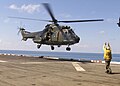 Singapore Super Puma lands on USS Inchon in 2001.